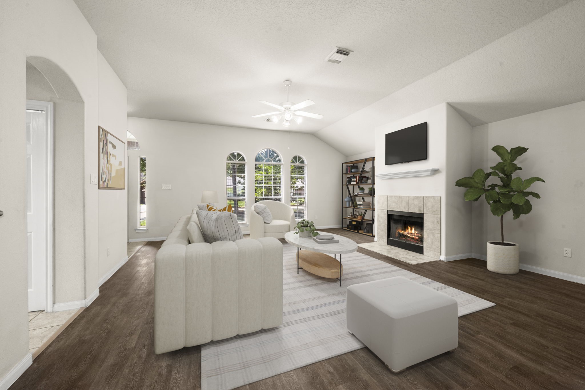 a living room with furniture a fireplace and a potted plant