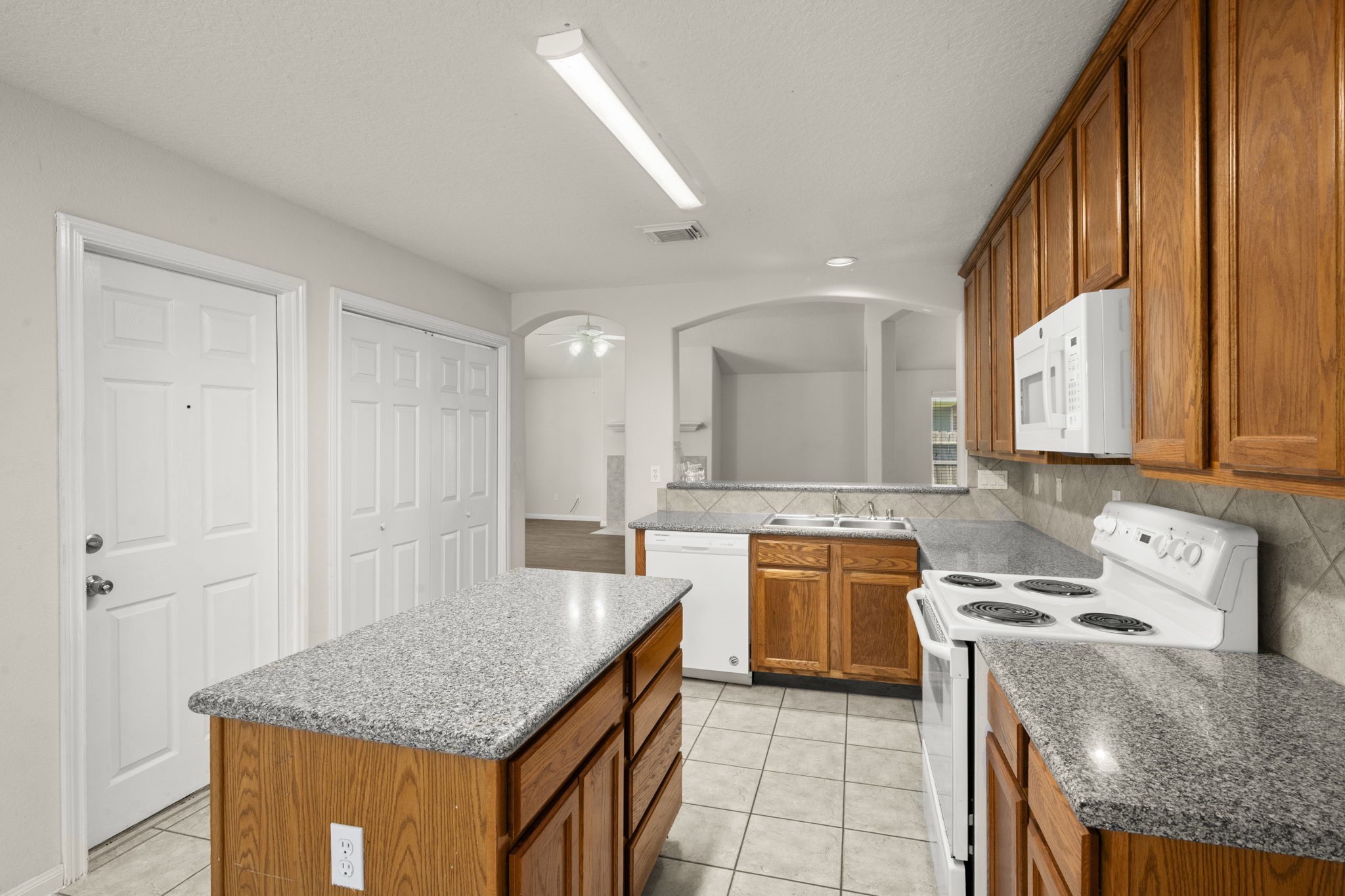 3226 Woodwind Road Montgomery, TX 77356 - Photo 16 of 34 a kitchen with a stove sink and cabinets
