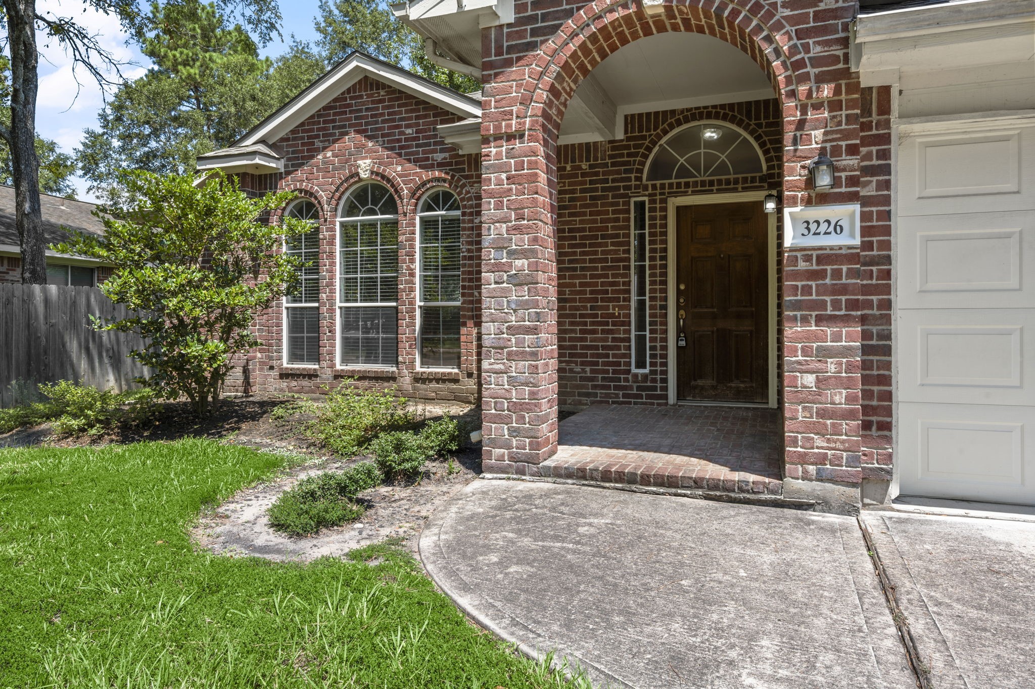 3226 Woodwind Road Montgomery, TX 77356 - Photo 2 of 34 a front view of a house with garden
