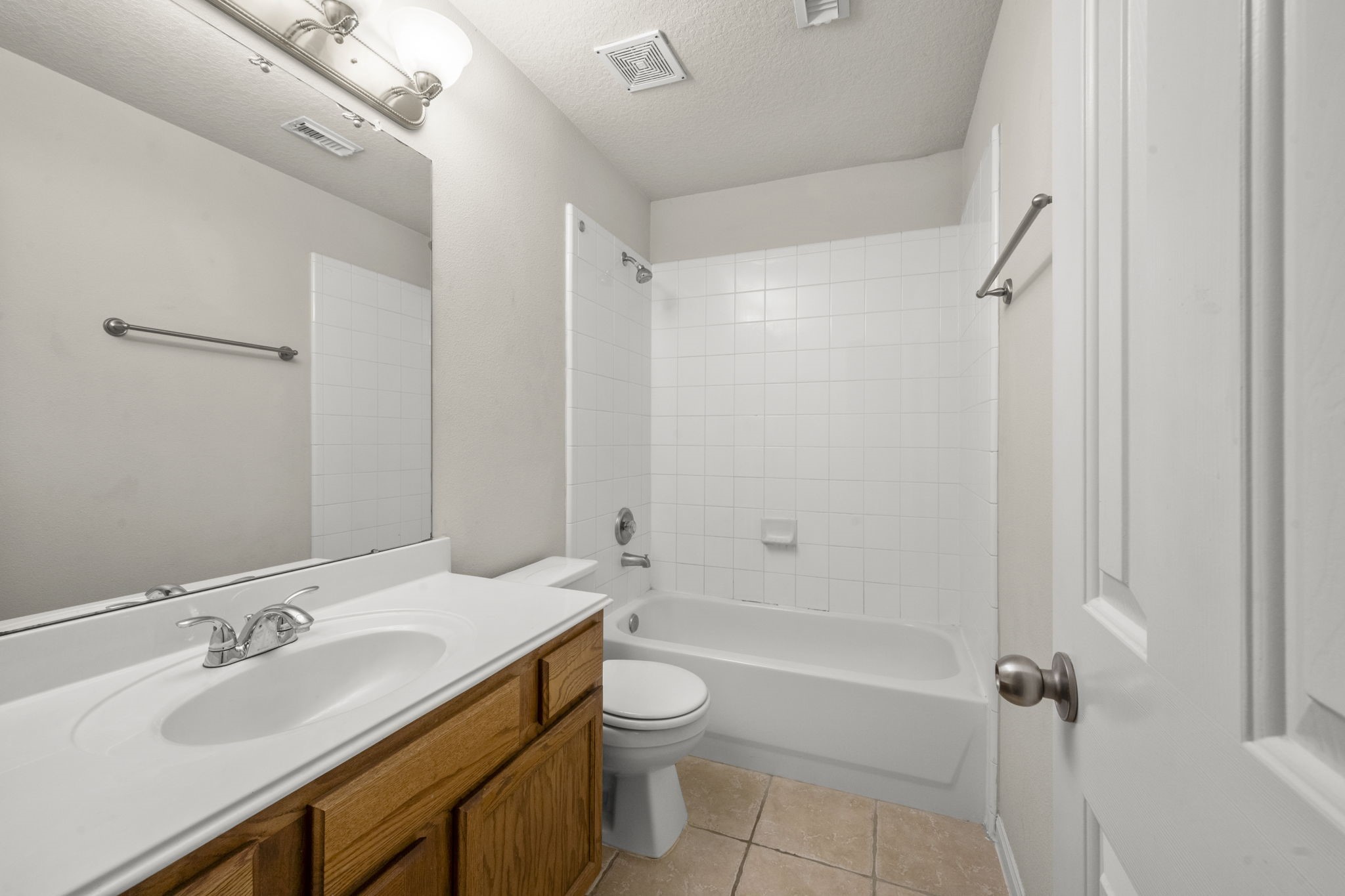 3226 Woodwind Road Montgomery, TX 77356 - Photo 21 of 34 a bathroom with a granite countertop sink toilet a shower and a mirror