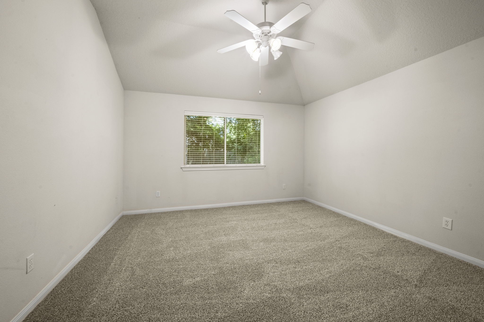 3226 Woodwind Road Montgomery, TX 77356 - Photo 24 of 34 an empty room with a window and a fan