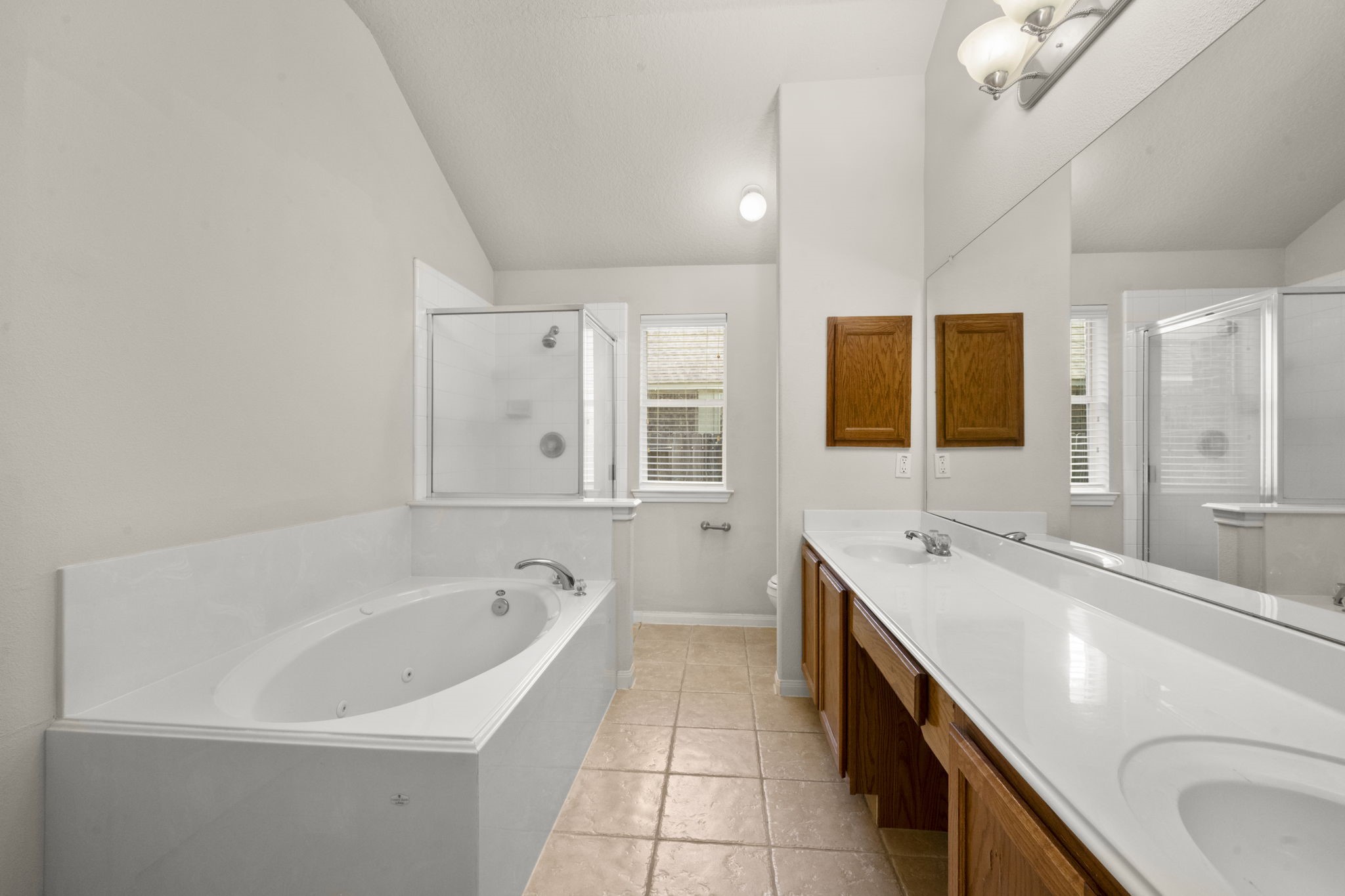 3226 Woodwind Road Montgomery, TX 77356 - Photo 25 of 34 a spacious bathroom with a bathtub sink and mirror