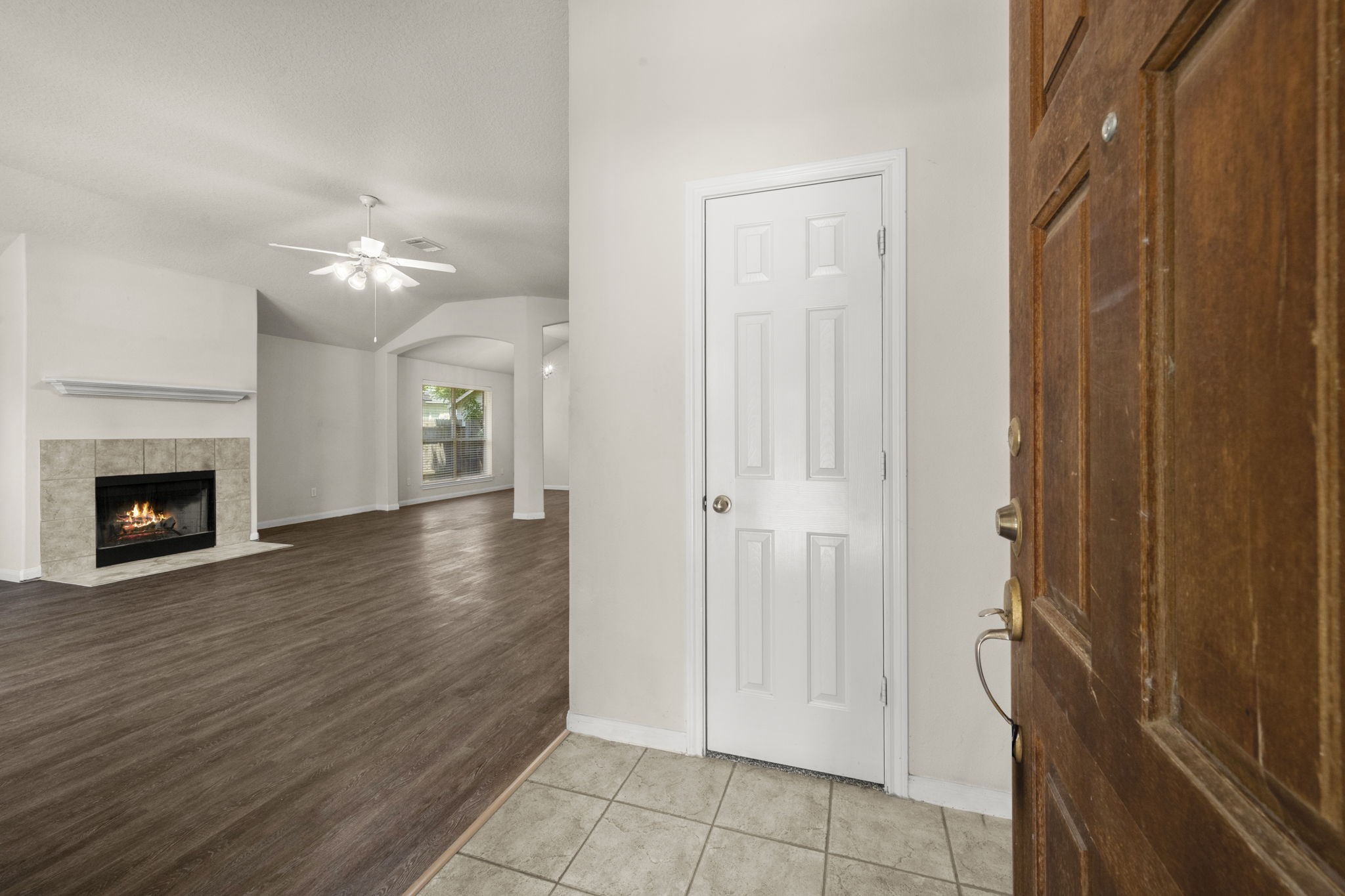 3226 Woodwind Road Montgomery, TX 77356 - Photo 3 of 34 a view of a hallway with wooden floor and a fireplace