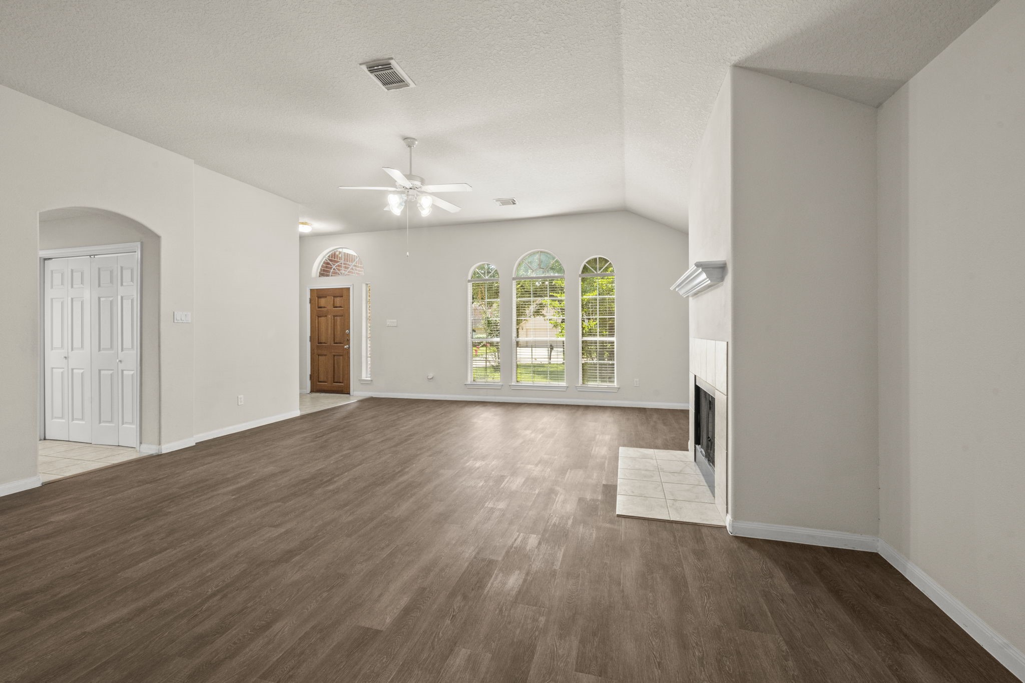 3226 Woodwind Road Montgomery, TX 77356 - Photo 9 of 34 an empty room with wooden floor and windows