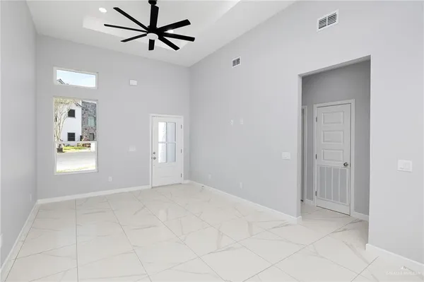 a view of a livingroom with a window and a ceiling fan
