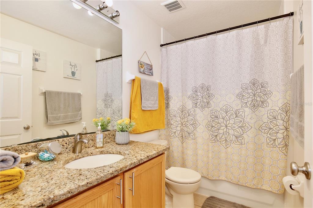 3415 Celena Circle St. Cloud, FL 34769 - Photo 12 of 20 a bathroom with a granite countertop sink and a mirror