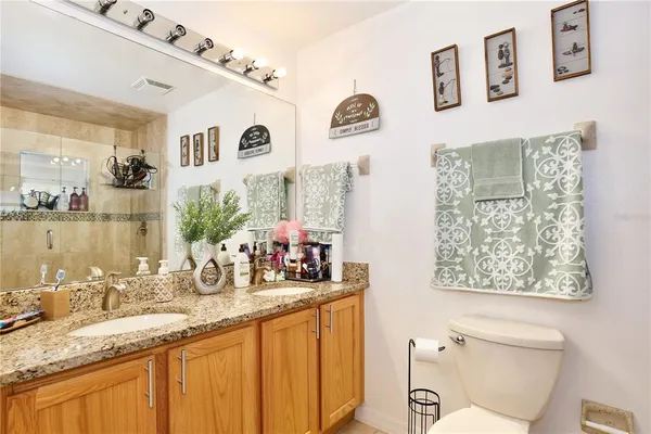 a bathroom with double vanity sink and a mirror