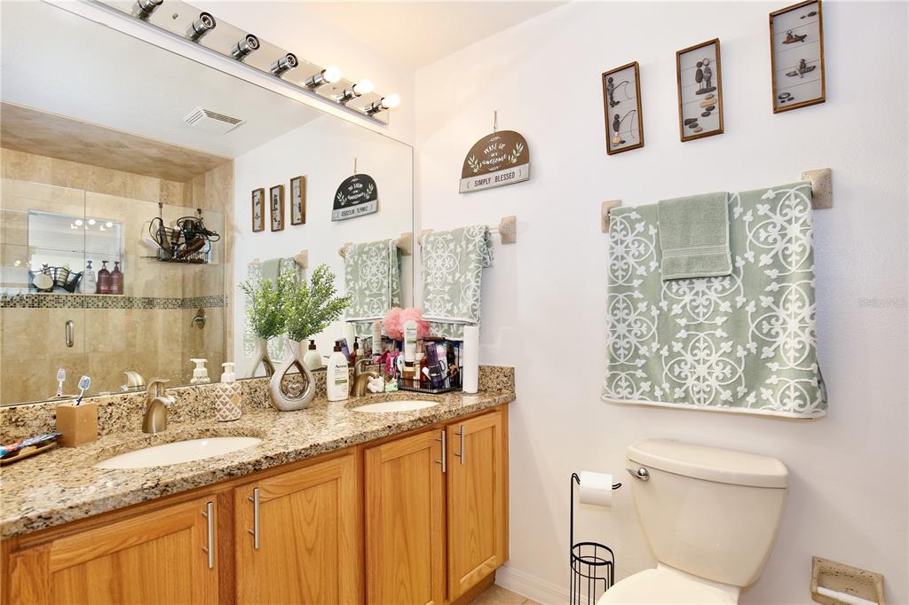 3415 Celena Circle St. Cloud, FL 34769 - Photo 13 of 20 a bathroom with double vanity sink and a mirror