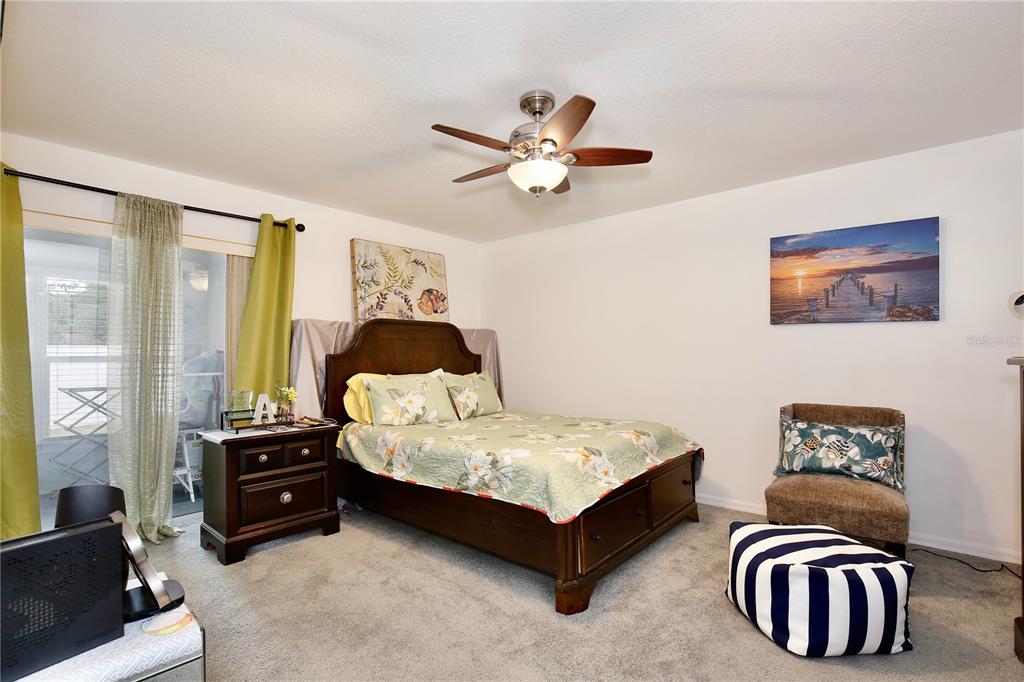 3415 Celena Circle St. Cloud, FL 34769 - Photo 15 of 20 a bedroom with a bed and a chandelier