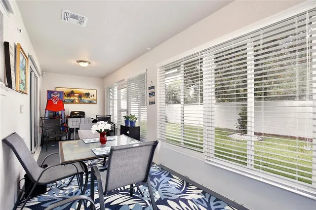 a view of a dining room with furniture and a window
