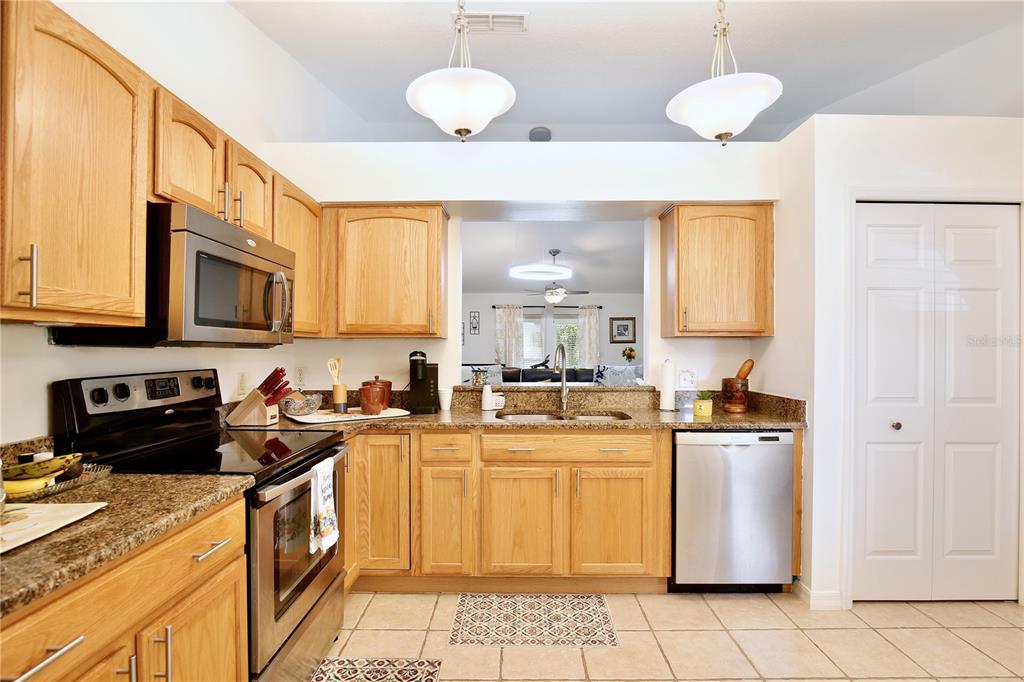 3415 Celena Circle St. Cloud, FL 34769 - Photo 7 of 20 a kitchen with a sink a stove and cabinets
