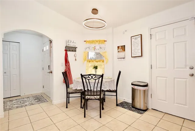 a view of a dining room with furniture and chandelier