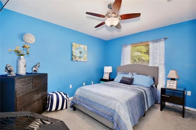a bedroom with two beds and a chandelier