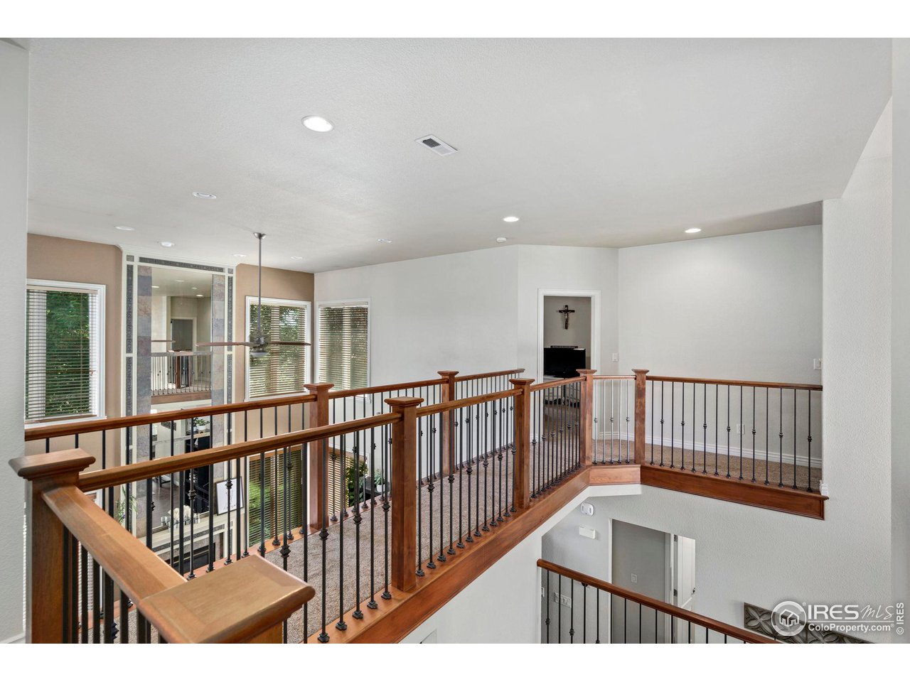7702 Plateau Road Greeley, CO 80634 - Photo 19 of 40 Upstairs Walk Way-Open with Natural Light Pouring into the Home!