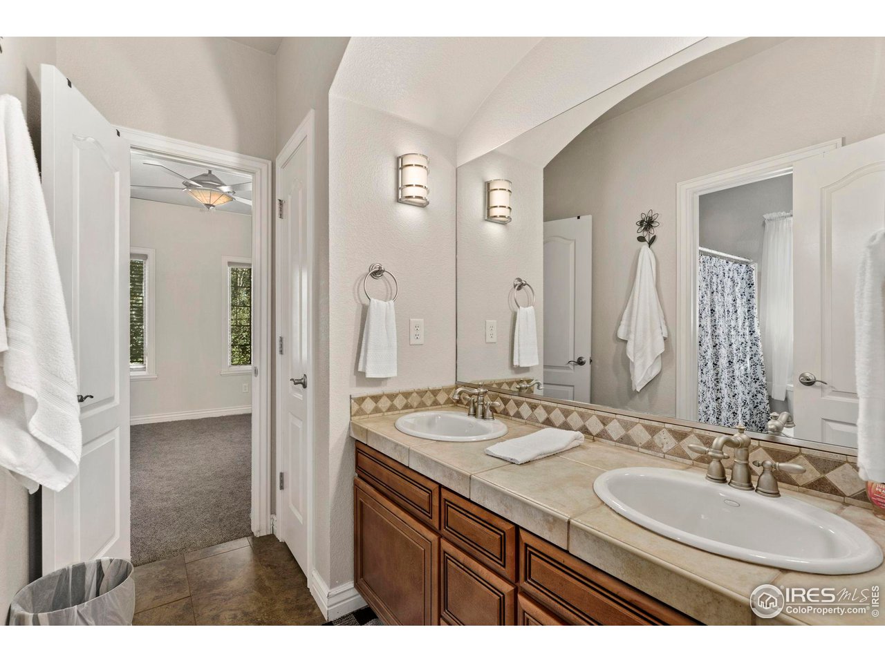 7702 Plateau Road Greeley, CO 80634 - Photo 23 of 40 Jack & Jill Bathroom leads to 5th Bedroom. Double Sinks & Tile Flooring!