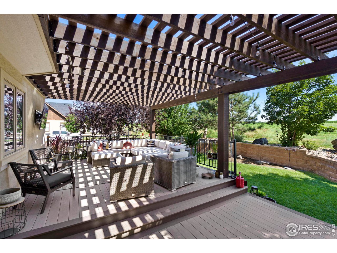 7702 Plateau Road Greeley, CO 80634 - Photo 32 of 40 Large Trex Decking with Cedar Pergola Providing Shade!