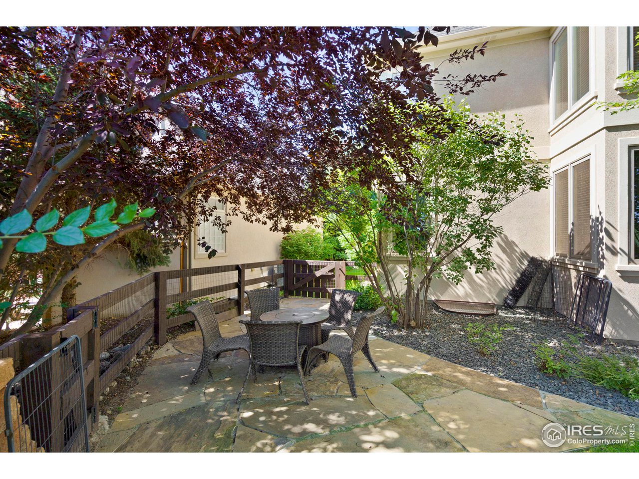 7702 Plateau Road Greeley, CO 80634 - Photo 33 of 40 Numerous Places to Entertain & Gather! Gather Around the Fire Pit on your Separate Back Flagstone Patio with Large Trees Providing Shade & Charm!