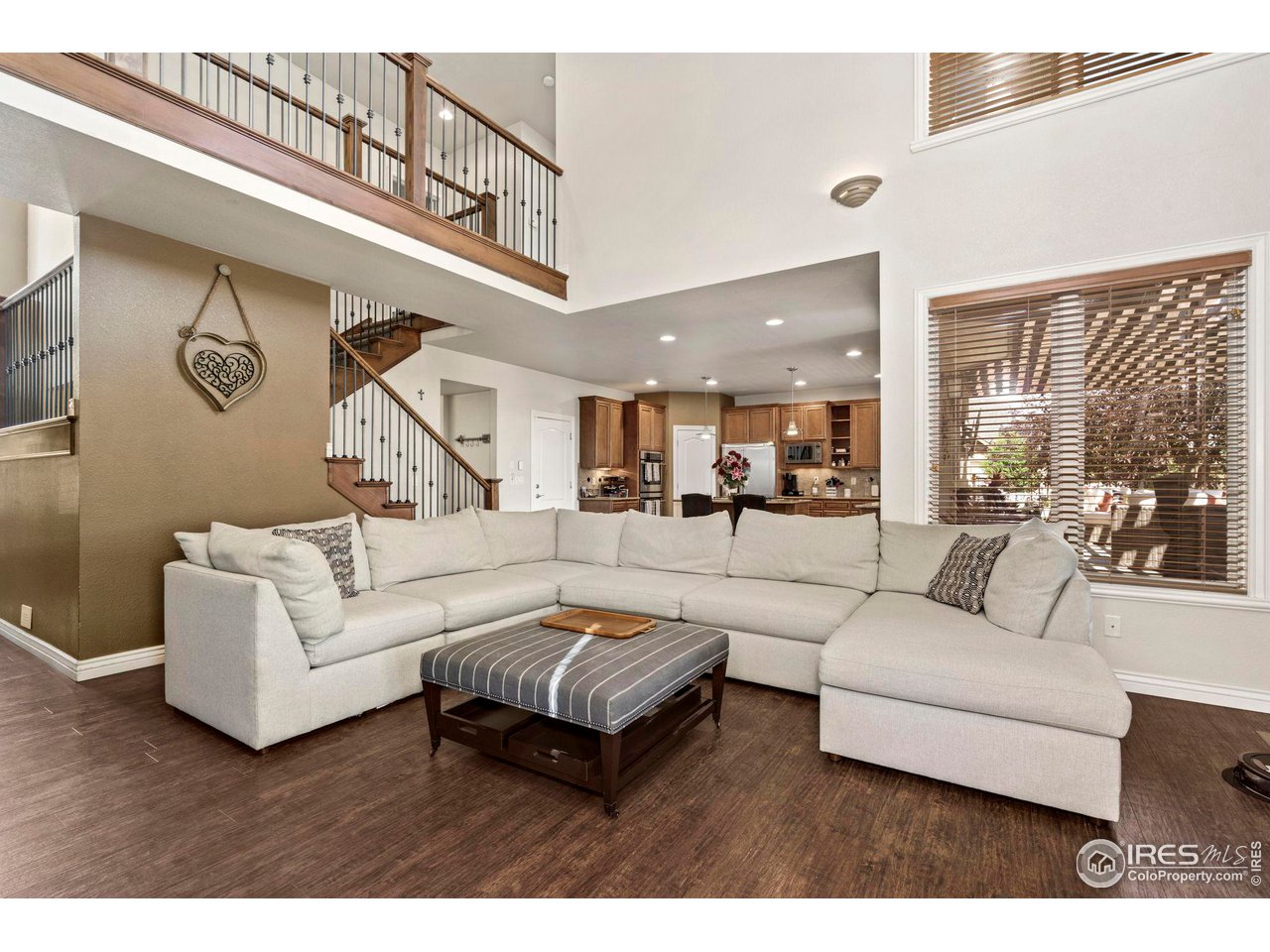 7702 Plateau Road Greeley, CO 80634 - Photo 40 of 40 Open Floor Plan Living- 2 Wrought Iron Staircase Entrances to Upstairs