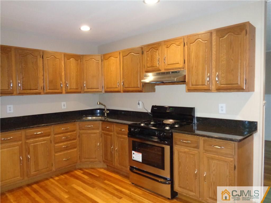 14 Bucknell Road Old Bridge, NJ 08859 - Photo 3 of 15 a kitchen with granite countertop a stove sink and cabinets