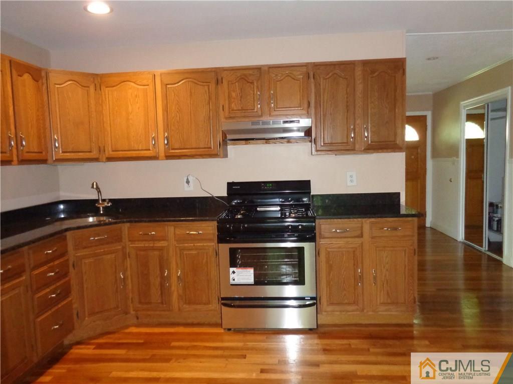 14 Bucknell Road Old Bridge, NJ 08859 - Photo 4 of 15 a kitchen with stainless steel appliances granite countertop a stove a sink and a microwave