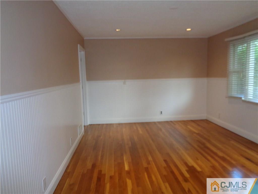 14 Bucknell Road Old Bridge, NJ 08859 - Photo 7 of 15 an empty room with wooden floor and windows
