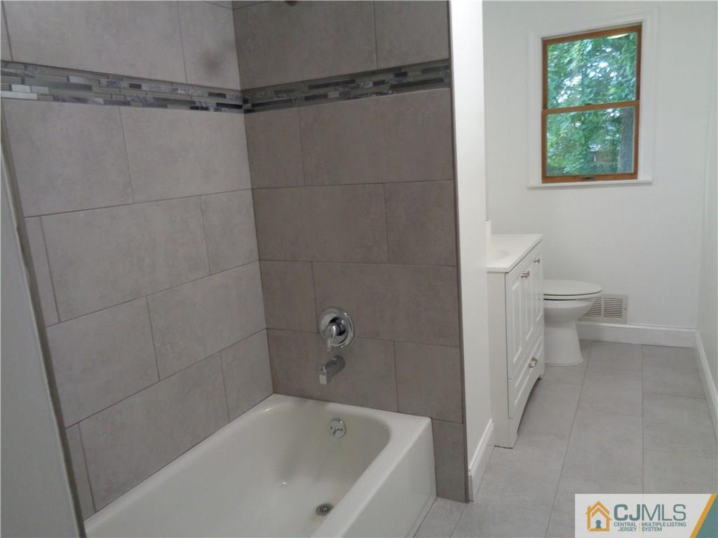 14 Bucknell Road Old Bridge, NJ 08859 - Photo 9 of 15 a bath room with a toilet and a bath tub