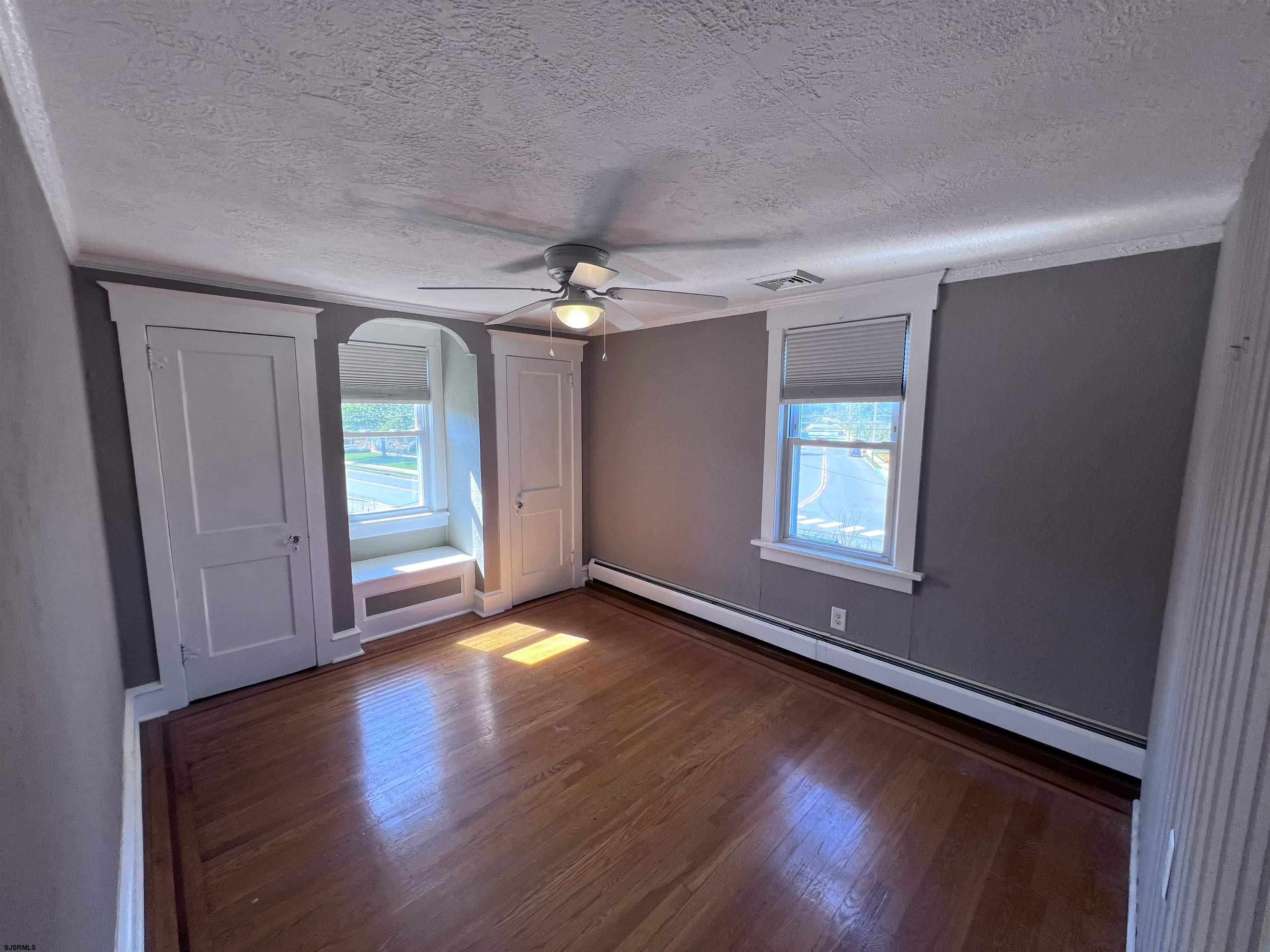 114 Shore Road, Unit YEARLY RENTAL Linwood, NJ 08221 - Photo 13 of 39 an empty room with wooden floor and windows