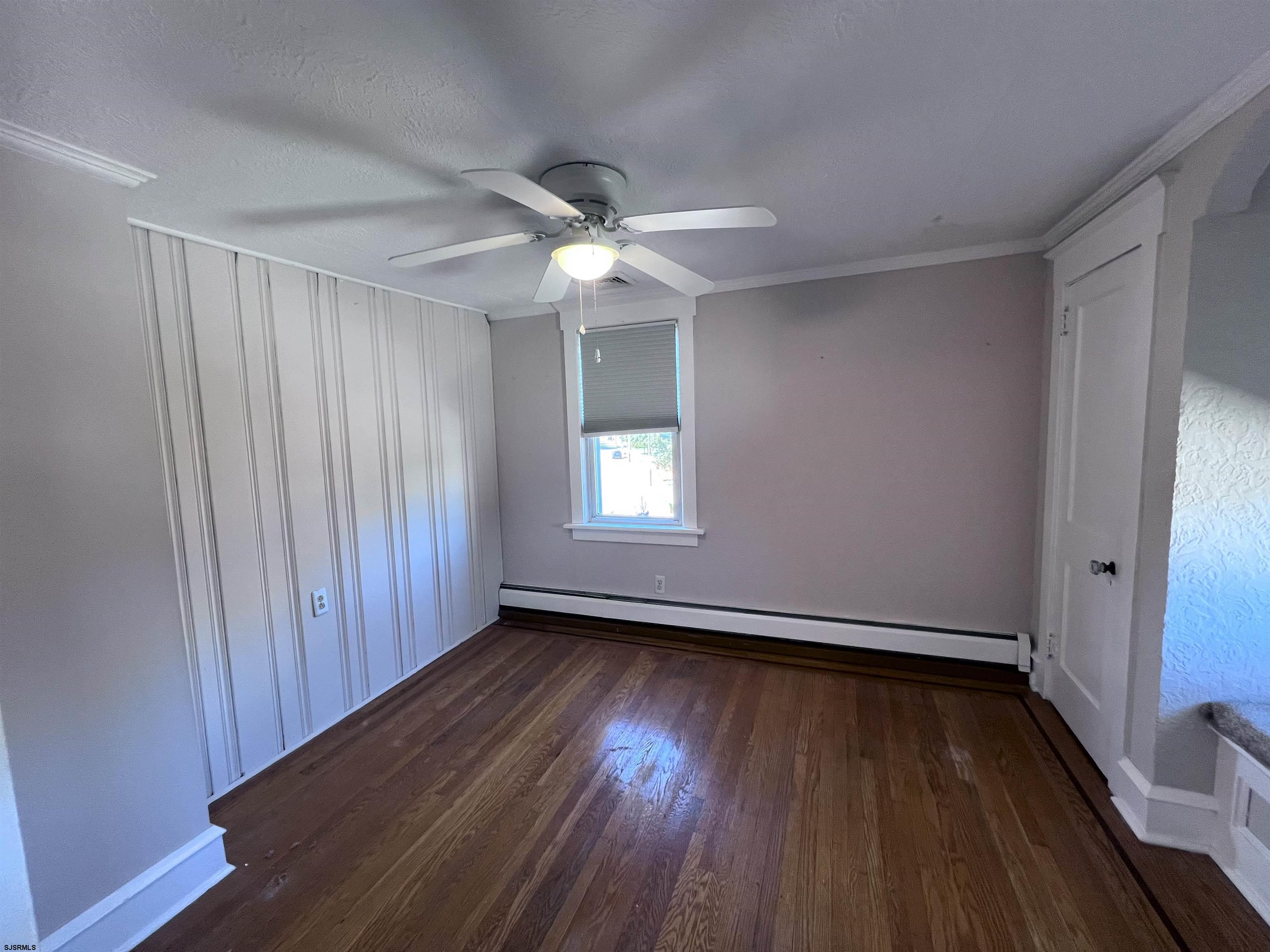 114 Shore Road, Unit YEARLY RENTAL Linwood, NJ 08221 - Photo 14 of 39 an empty room with wooden floor fan and windows
