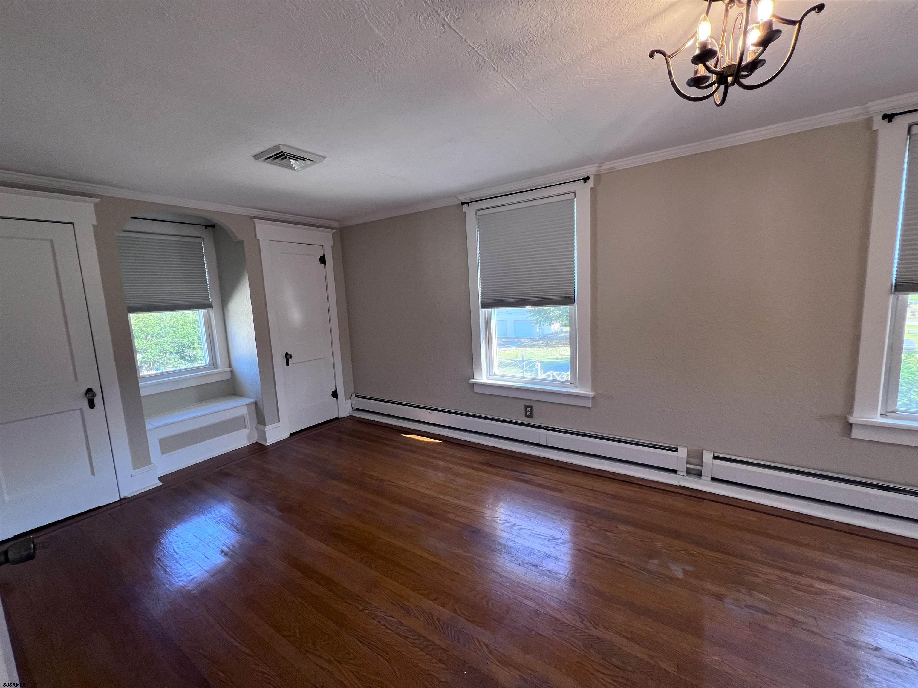 114 Shore Road, Unit YEARLY RENTAL Linwood, NJ 08221 - Photo 20 of 39 a view of an empty room with wooden floor and a window