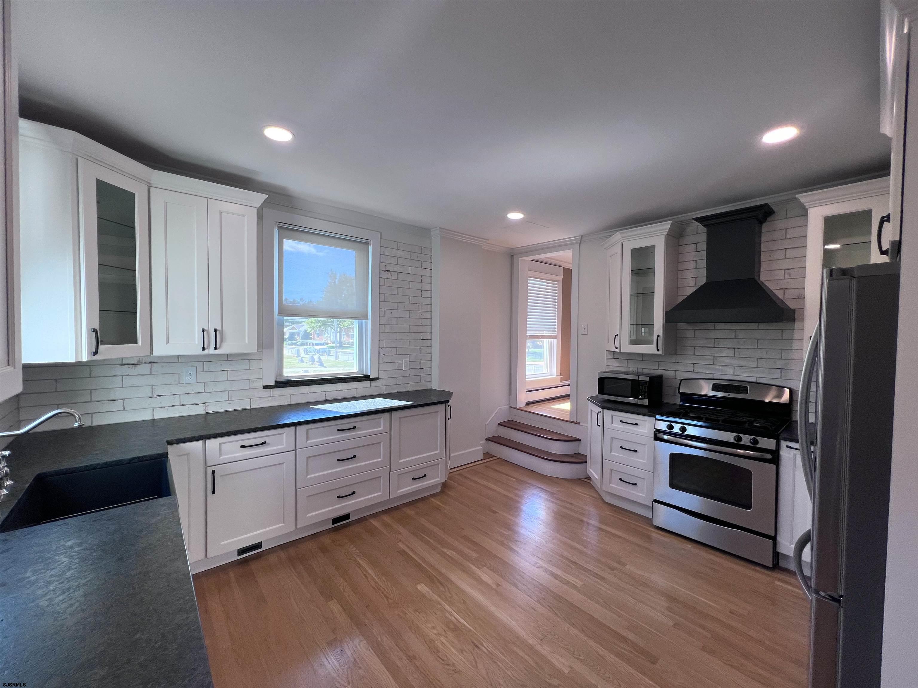 114 Shore Road, Unit YEARLY RENTAL Linwood, NJ 08221 - Photo 8 of 39 a large kitchen with stainless steel appliances granite countertop a stove and a wooden floors