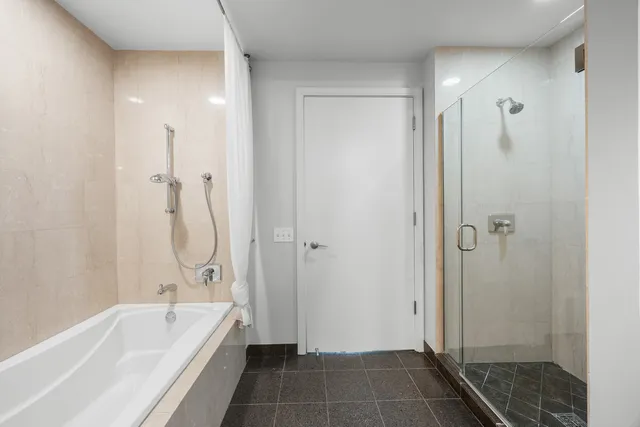 a bathroom with a bathtub and a shower