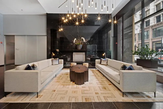 a living room with furniture and a chandelier