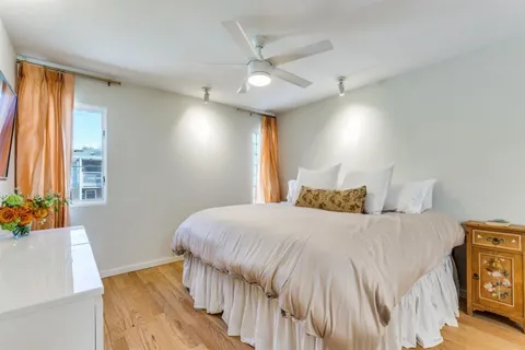 a bedroom with a bed and a potted plant