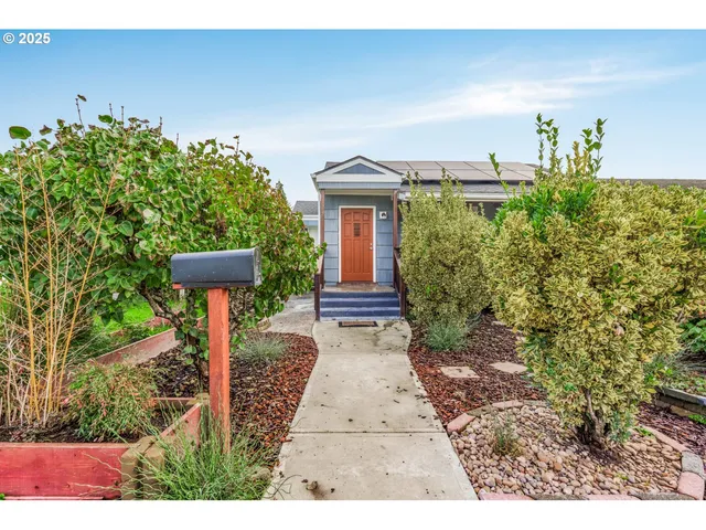 a front view of a house with garden