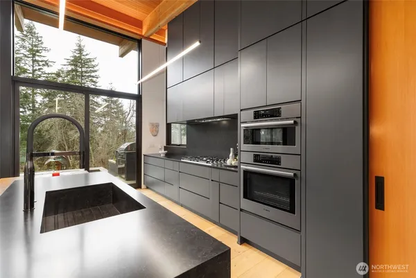a kitchen with stainless steel appliances a stove a sink and a refrigerator