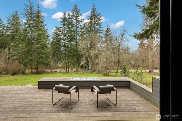 a view of a swimming pool with a yard and furniture