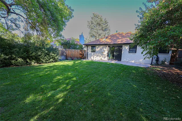 a view of a house with a yard and sitting area