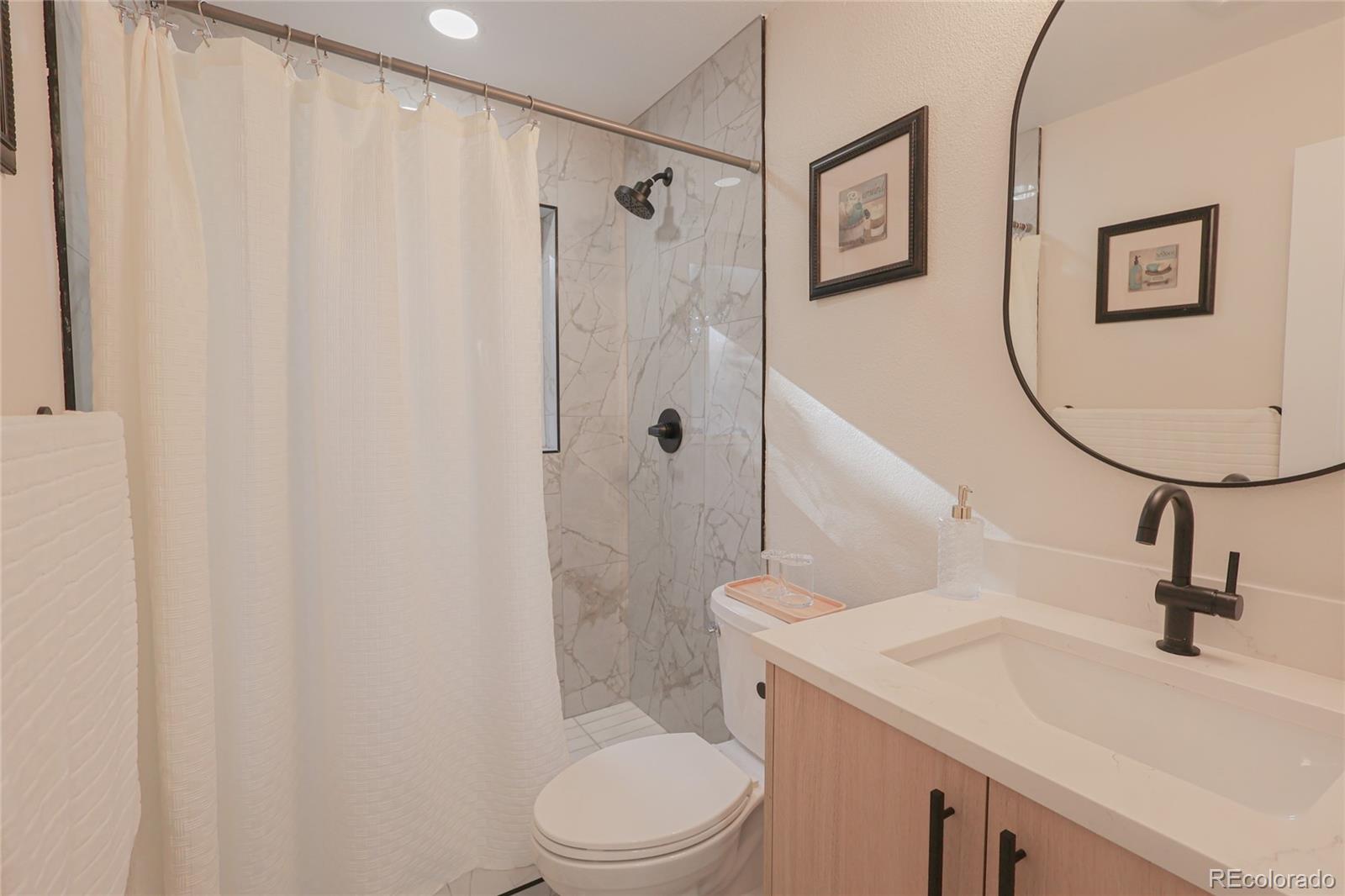 1045 Locust Street Denver, CO 80220 - Photo 8 of 18 a bathroom with a sink a toilet and shower