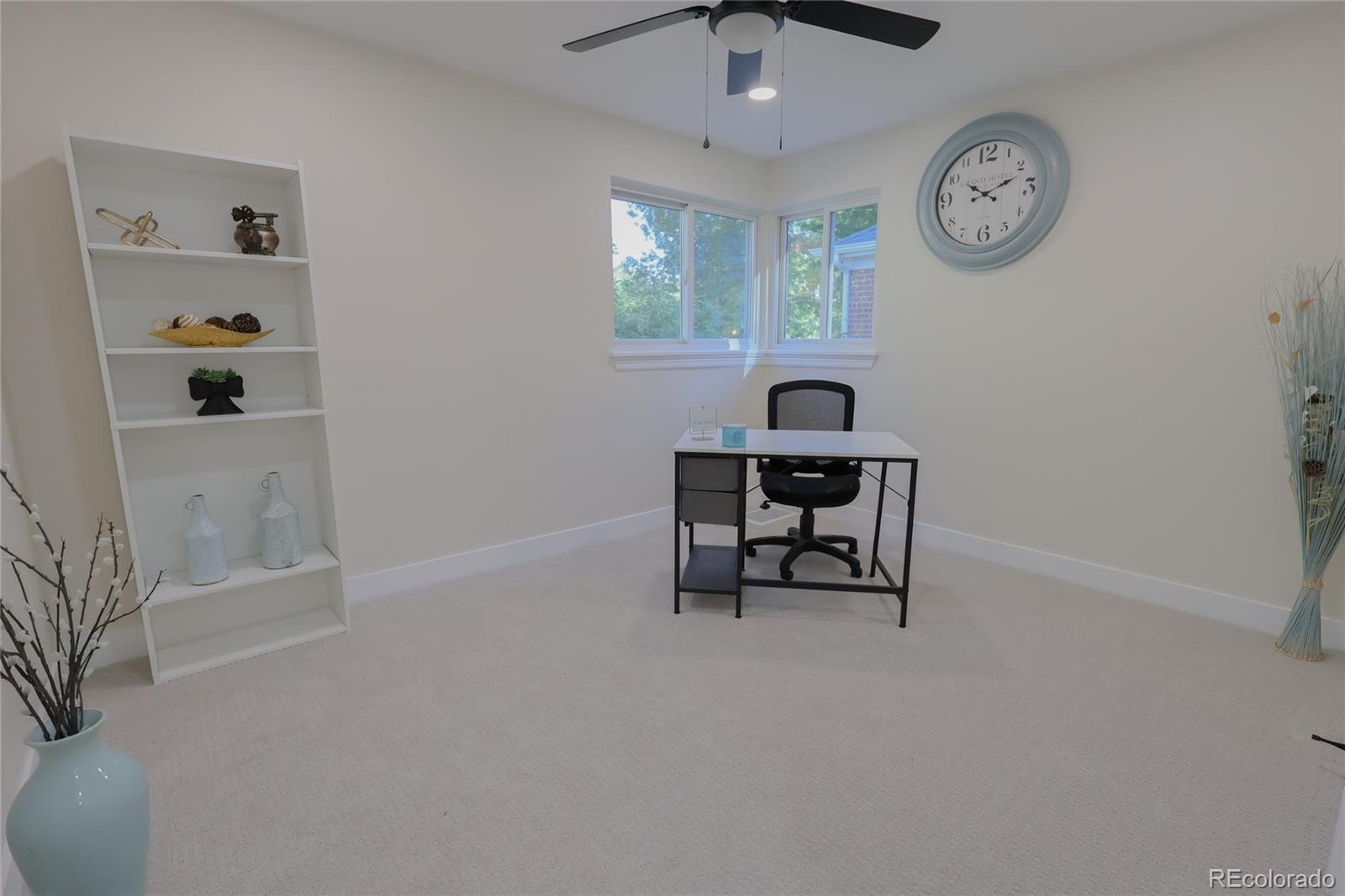 1045 Locust Street Denver, CO 80220 - Photo 9 of 18 a living room with furniture and a clock