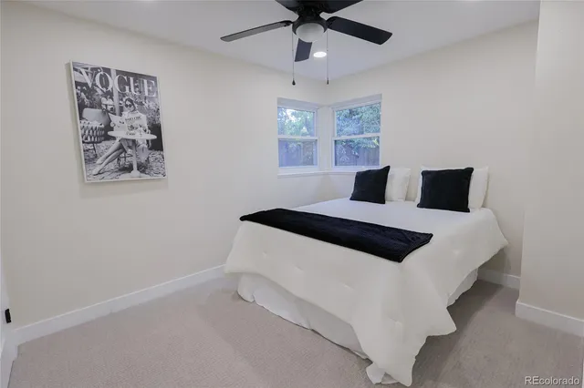 a bedroom with a bed and a painting on the wall
