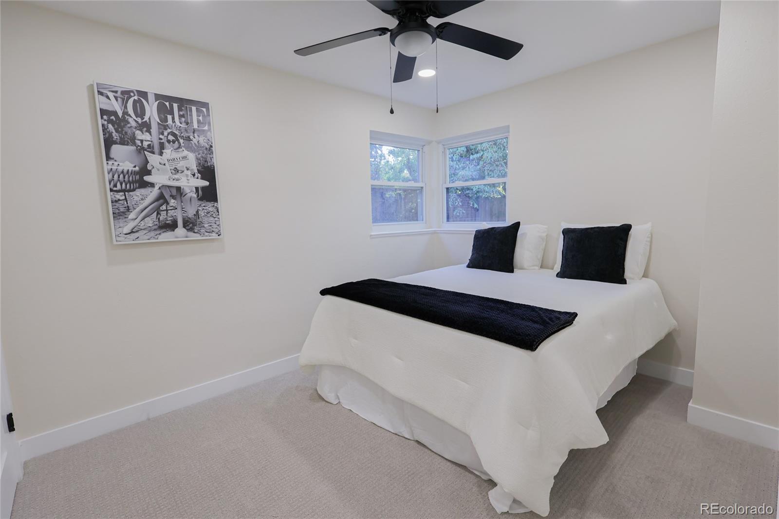1045 Locust Street Denver, CO 80220 - Photo 10 of 18 a bedroom with a bed and a painting on the wall