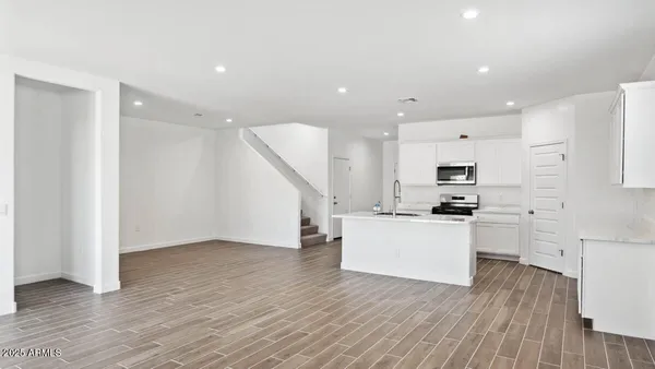 a kitchen with stainless steel appliances a refrigerator and a stove top oven