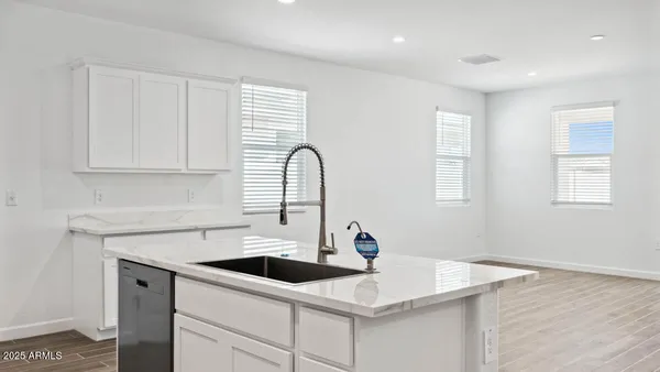 a kitchen with a sink cabinets and window
