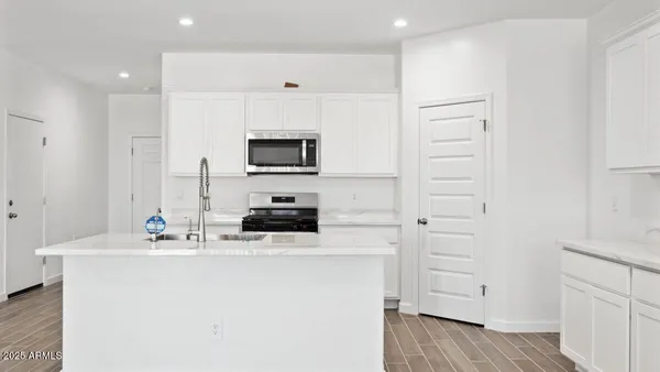 a kitchen with stainless steel appliances a refrigerator stove and microwave