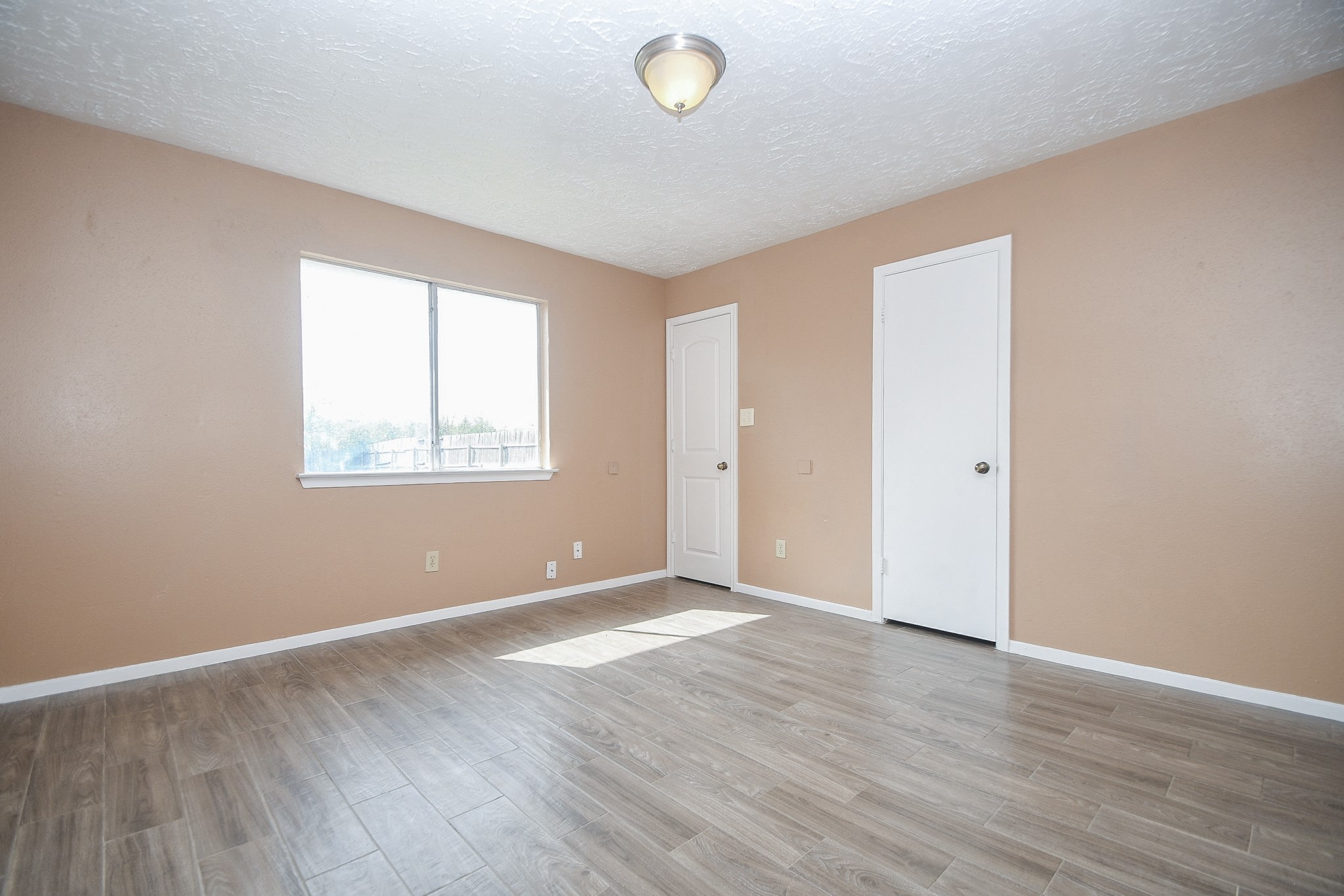 5411 Regal Ridge Lane Houston, TX 77053 - Photo 12 of 20 an empty room with wooden floor and windows