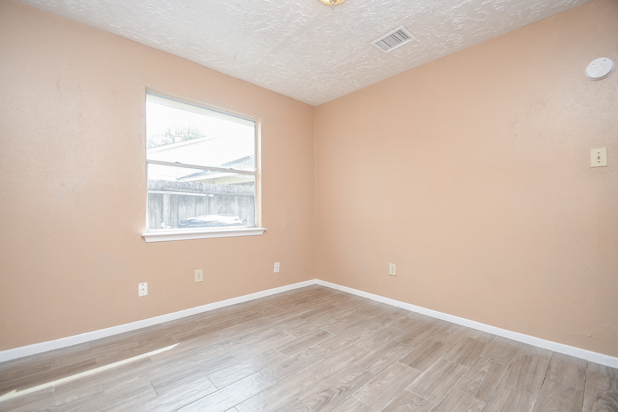 5411 Regal Ridge Lane Houston, TX 77053 - Photo 16 of 20 an empty room with wooden floor and windows