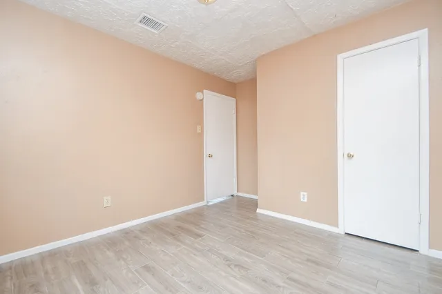 an empty room with wooden floor