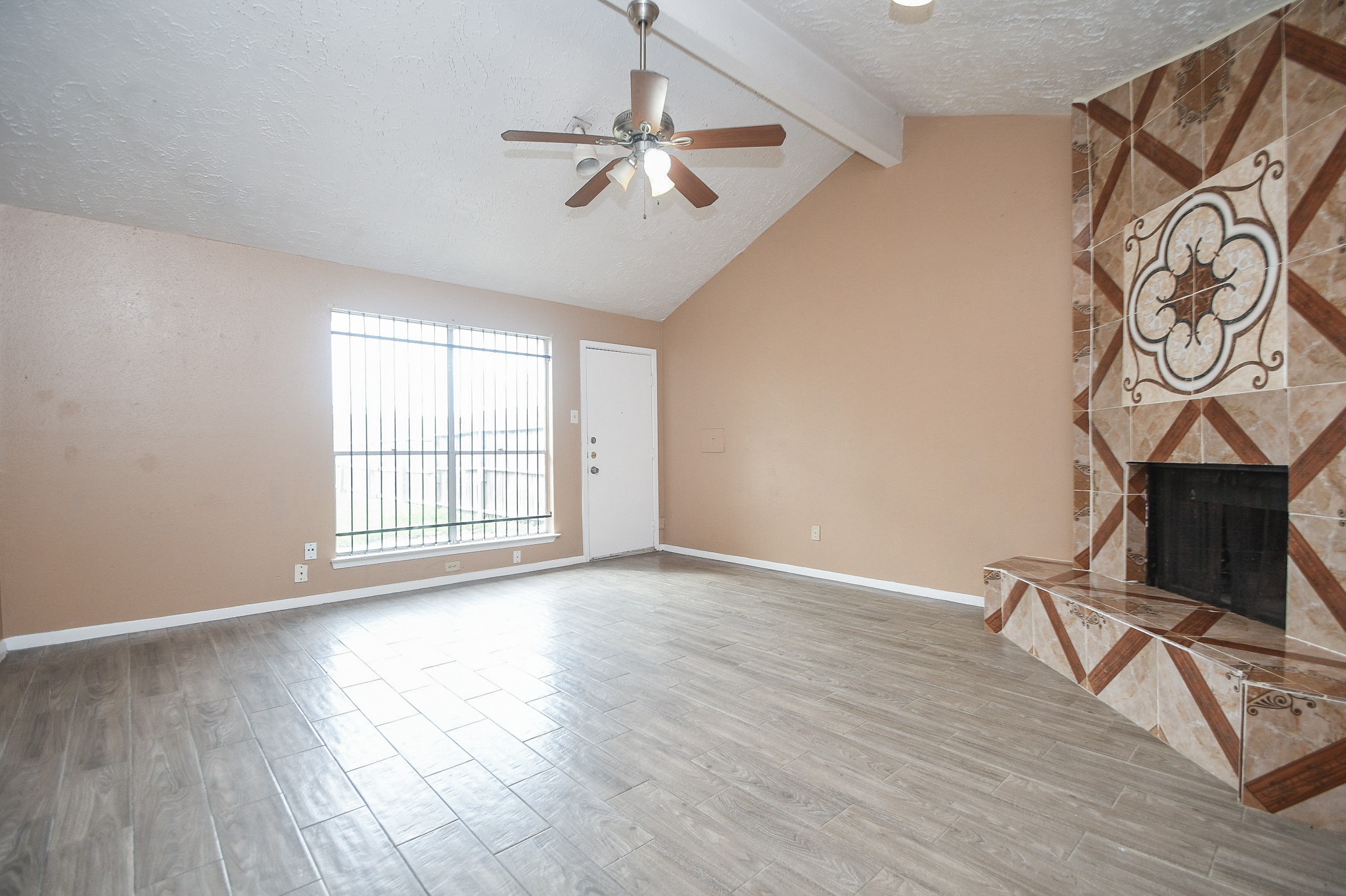 5411 Regal Ridge Lane Houston, TX 77053 - Photo 4 of 20 a view of an empty room with a window and wooden floor