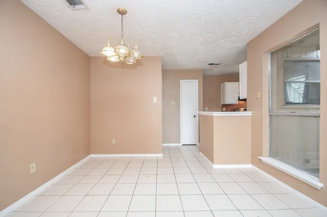 a view of a kitchen with cabinet and a chandelier fan