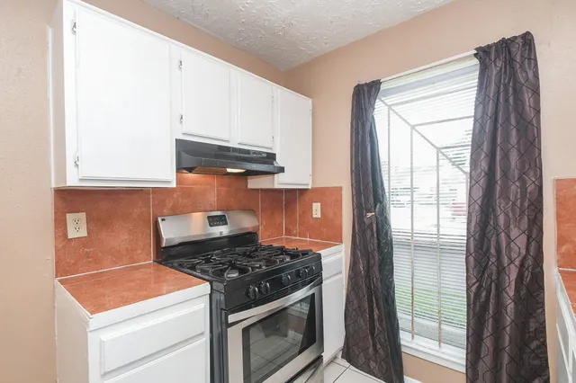 a kitchen with a stove and a microwave